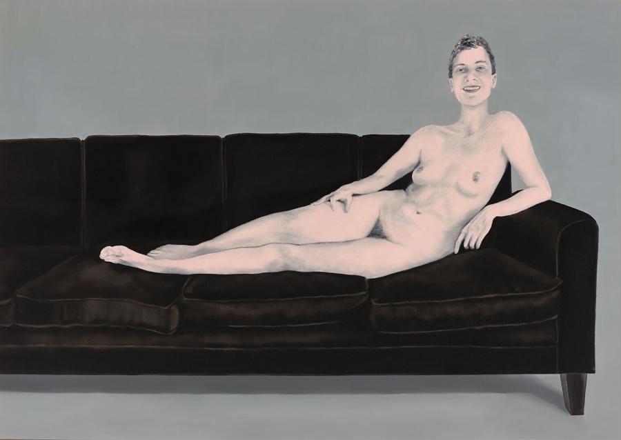 Naked woman on black couch