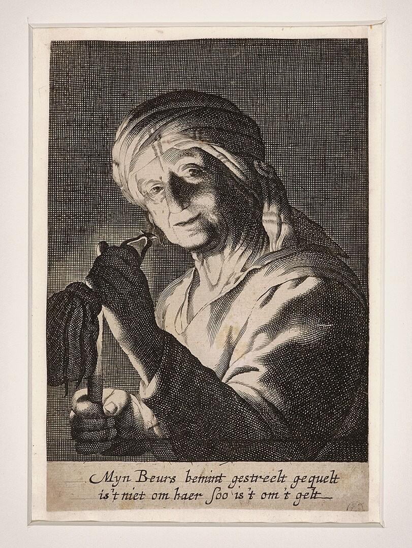 Oude vrouw bij kaarslicht