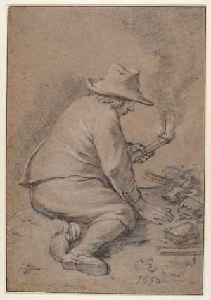 a-man-sits-on-the-ground-with-a-torch-in-his-hand